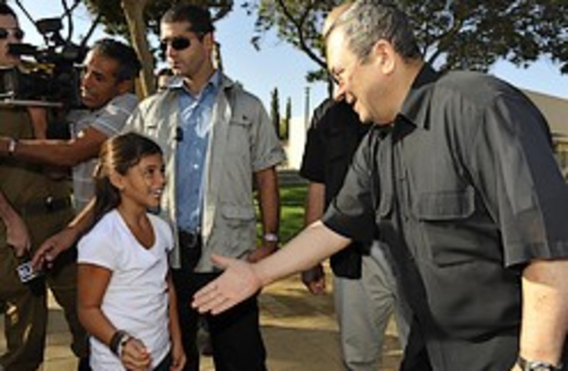 Barak shakes hand girl 248 mod (photo credit: Defense Ministry)