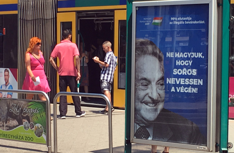 Hungarian government poster portraying financier George Soros and saying "Don't let George Soros have the last laugh" is seen at a tram stop in Budapest, Hungary (photo credit: REUTERS/KRISZTINA THAN)