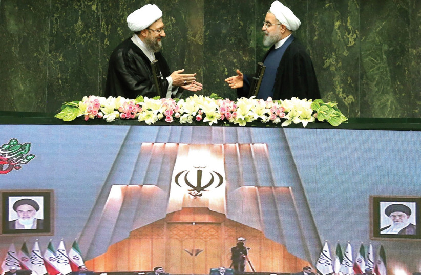 Hassan Rouhani (right) and Sadeq Larijani (left) at the parliament in Tehran Iran (photo credit: REUTERS)