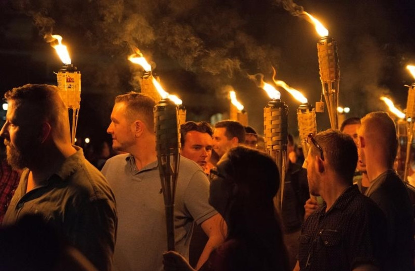 White nationalists carry torches on the grounds of the University of Virginia, on the eve of a planned Unite The Right rally in Charlottesville, Virginia, U.S. August 11, 2017. Picture taken August 11, 2017. (photo credit: ALEJANDRO ALVAREZ/NEWS2SHARE VIA REUTERS)