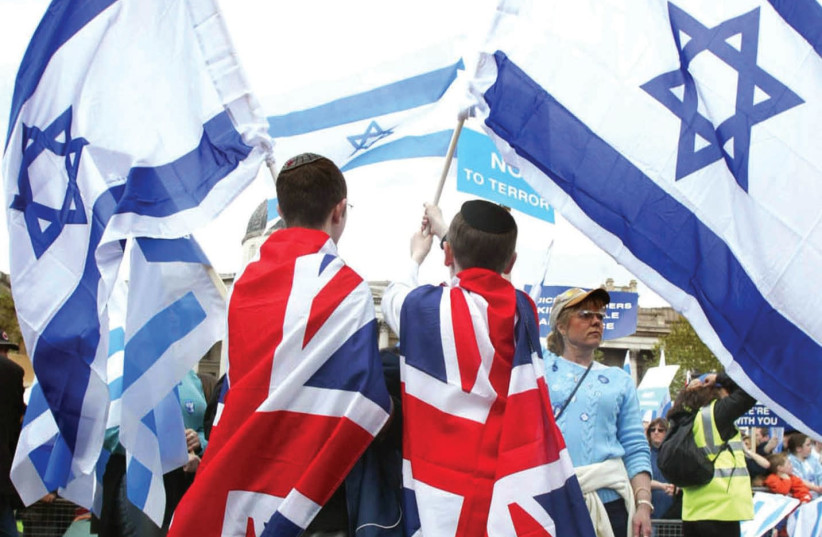 UK AND Israeli flags together at a march in London. (photo credit: REUTERS)