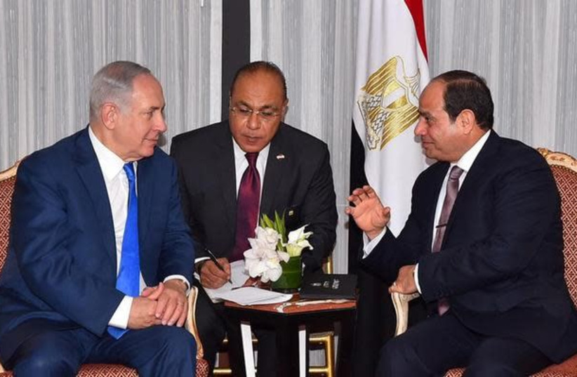 Egyptian President Abdel Fattah al-Sisi (R) speaks with Israeli Prime Minister Benjamin Netanyahu (L) during their meeting as part of an effort to revive the Middle East peace process ahead of the United Nations General Assembly in New York, U.S., September 19, 2017 in this handout picture courtesy  (photo credit: REUTERS)