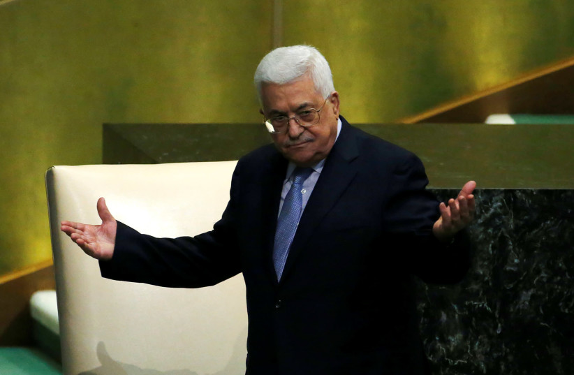 Palestinian President Mahmoud Abbas greets delegates after addressing the 72nd United Nations General Assembly at U.N. headquarters in New York, US, September 20, 2017.  (photo credit: EDUARDO MUNOZ / REUTERS)