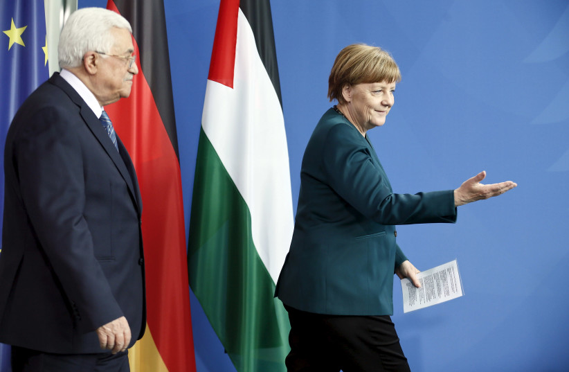 Chancellor Angela Merkel and Palestinian President Mahmoud Abbas arrive for a news conference at the Chancellery in Berlin, Germany, April 19, 2016. (photo credit: REUTERS)