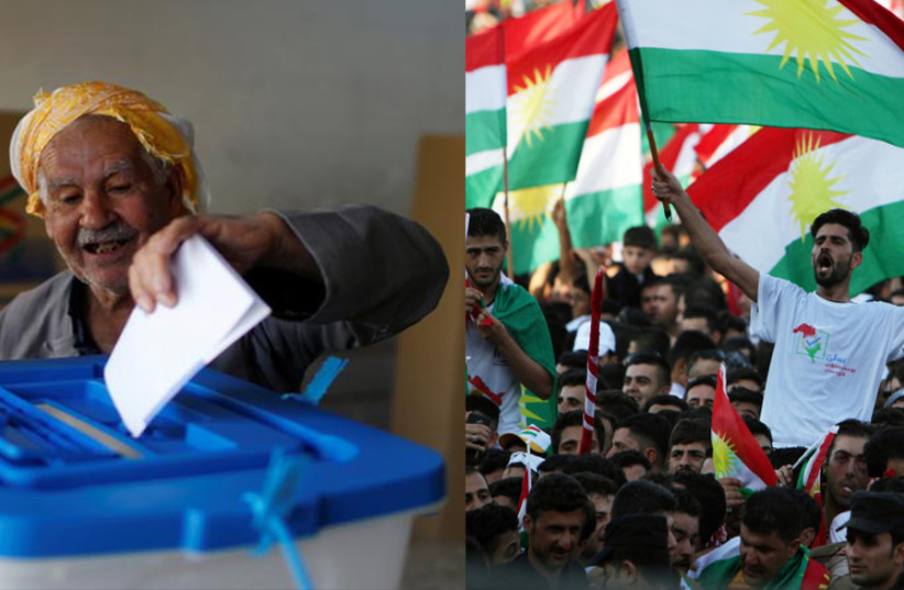 A man casts his vote during Kurds independence referendum in Erbil, Iraq September 25, 2017, beside a picture of Kurds showing their support for the Kurdish independence referendum. (photo credit: AHMED JADALLAH / REUTERS)