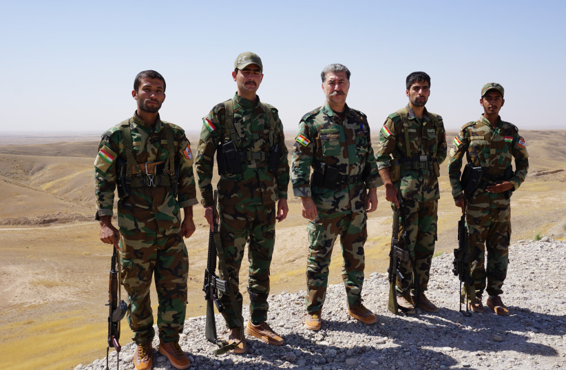Kurdish Peshmerga (center) leader Hussein Yazdanpanah with his men on the frontline with ISIS west of Kirkuk (photo credit: SETH J. FRANTZMAN)