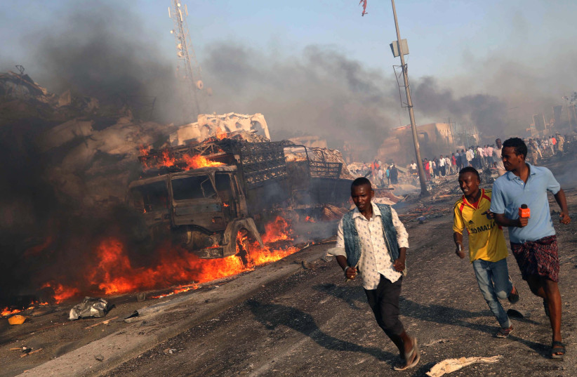 Civilians evacuate from the scene of an explosion in KM4 street in the Hodan district of Mogadishu, Somalia October 14, 2017. (photo credit: FEISAL OMAR/REUTERS)