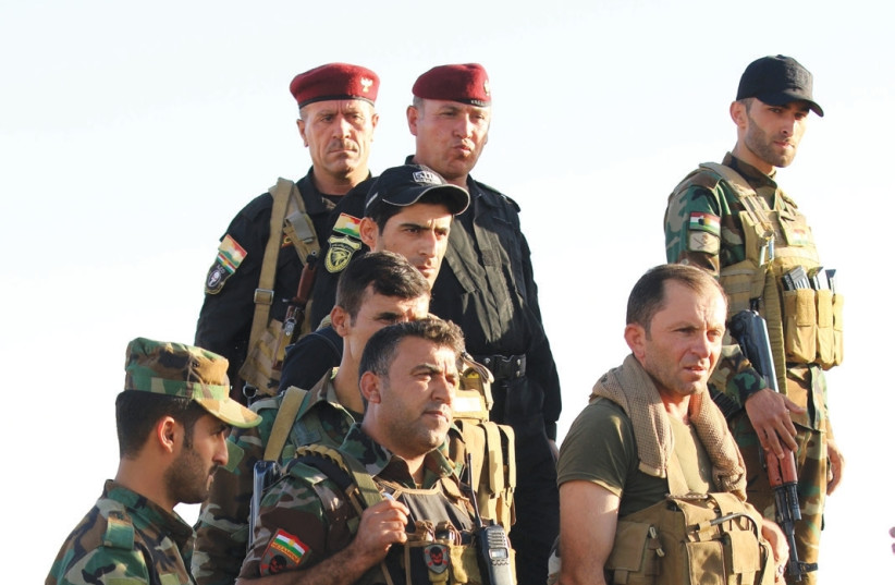 Kurdish Peshmerga fighters are seen yesterday in the Karez area west of Mosul, Iraq. (photo credit: ARI JALAL / REUTERS)