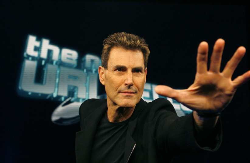 Israeli psychic Uri Geller poses for photographers in Cologne (photo credit: REUTERS/INA FASSBENDER)