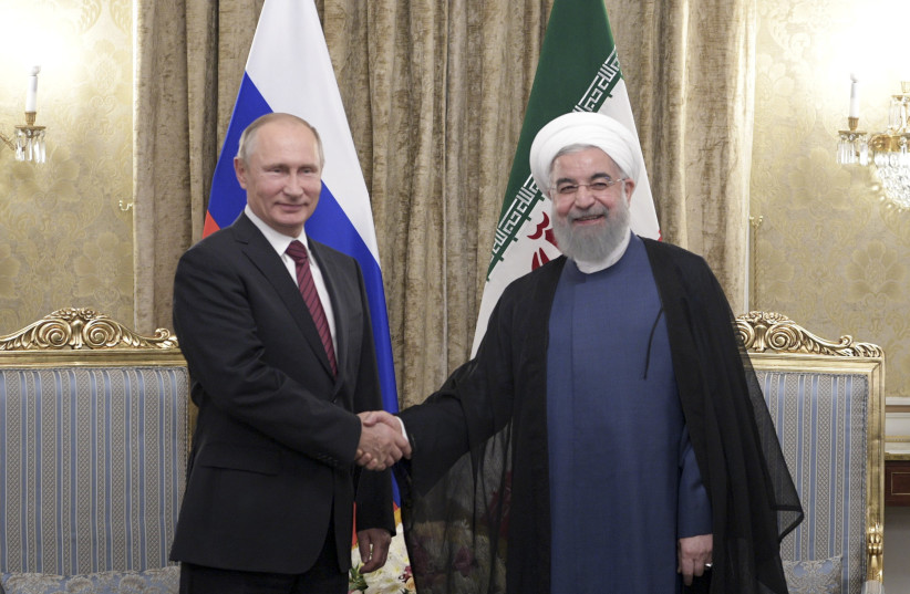 Russian President Vladimir Putin (L) shakes hands with his Iranian counterpart Hassan Rouhani during a meeting in Tehran, Iran November 1, 2017. (photo credit: SPUTNIK/ALEXEI NIKOLSKY/KREMLIN VIA REUTERS)