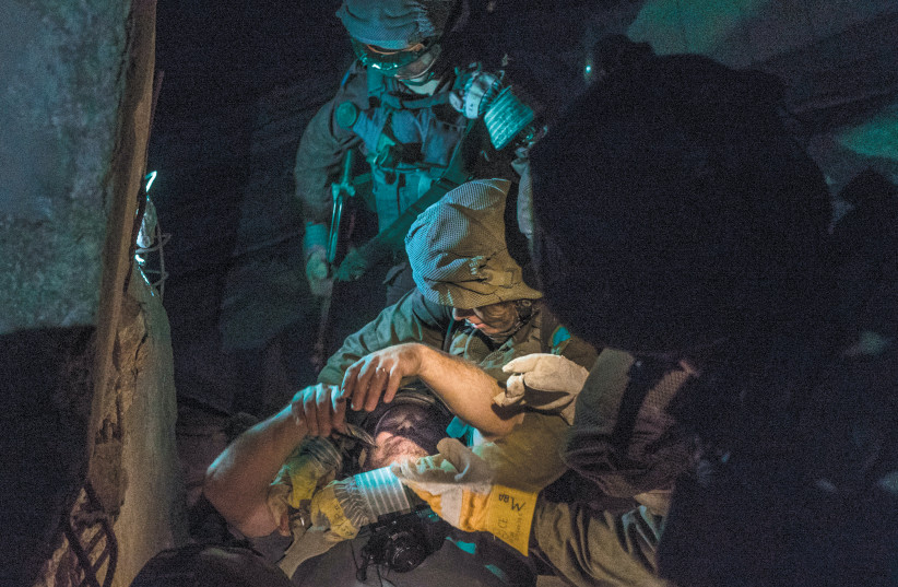 THE WRITER being ‘rescued’ by members of the Search-and-Rescue Unit (photo credit: IDF SPOKESPERSON'S UNIT)