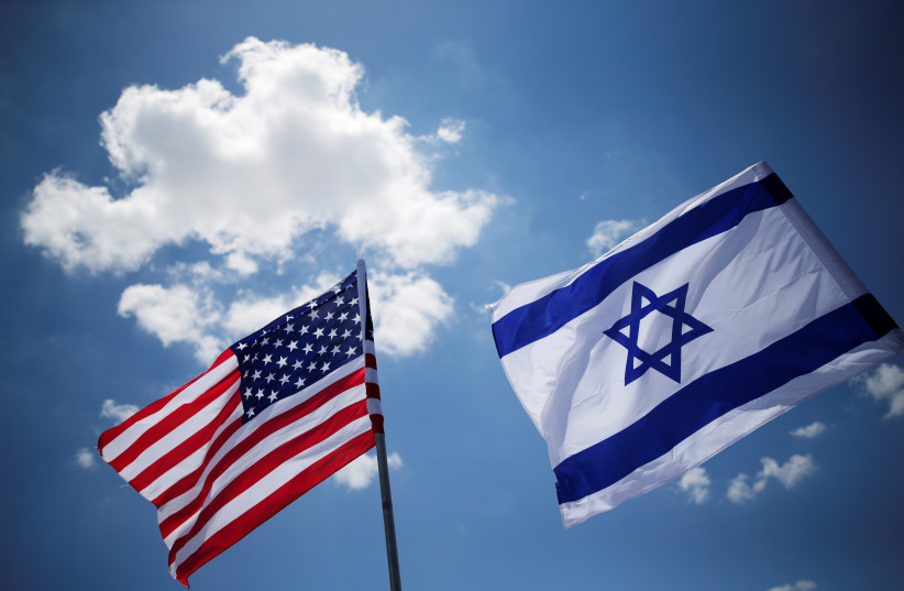 American and Israeli flags (photo credit: AMIR COHEN - REUTERS)