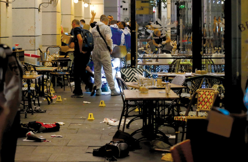 Police work the scene of the June 8, 2016, shooting attack at a restaurant at the Sarona Market in Tel Aviv (photo credit: AMMAR AWAD/REUTERS)