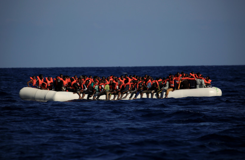 An overcrowded dinghy with migrants from different African countries is seen during a rescue operation off the Libyan coast in the Mediterranean Sea September 21, 2016. (photo credit: REUTERS)