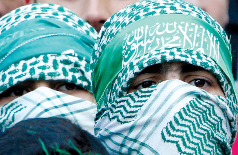 HAMAS SUPPORTERS take part in a rally in Nablus marking the 30th anniversary of the movement’s founding. (photo credit: REUTERS)