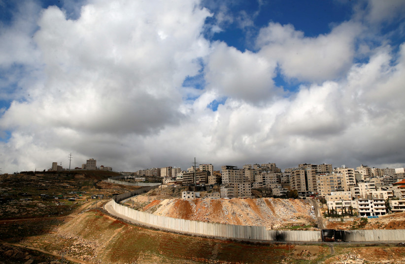 A general view picture shows the Israeli barrier running along the East Jerusalem refugee camp of Shuafat (photo credit: REUTERS)