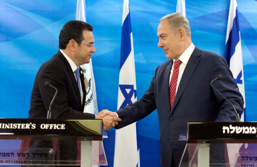 Guatemalan President Jimmy Morales and Israeli Prime Minister Benjamin Netanyahu shake hands as they deliver statements to the media during their meeting in Jerusalem, Israel. (photo credit: REUTERS)
