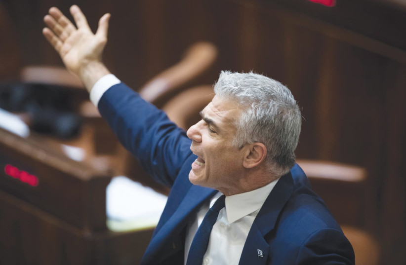 Yesh Atid chairman Yair Lapid declaims during the filibuster on Wednesday night, ahead of the Knesset vote on the Police Recommendations Bill (photo credit: HADAS PARUSH/FLASH90)