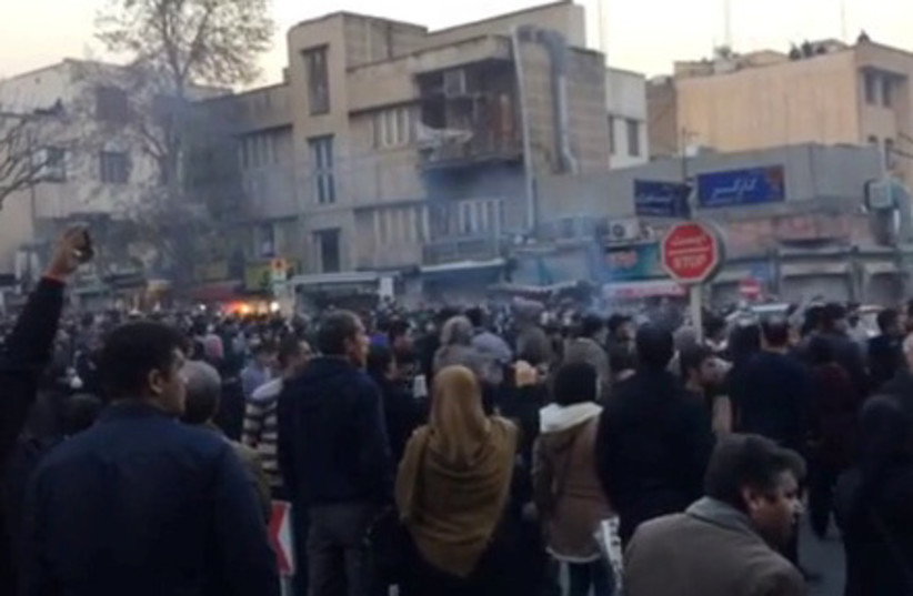 People protest in Tehran, Iran December 30, 2017 in this still image from a video obtained by REUTERS (photo credit: REUTERS)
