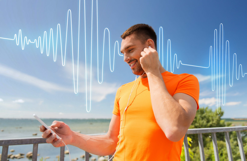 A runner listening to a podcast. (Illustrative) (photo credit: INGIMAGE)