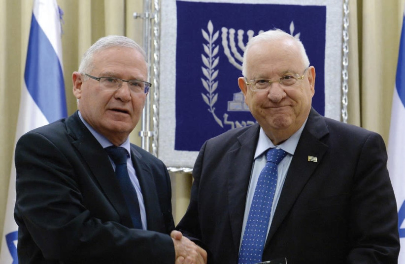 INSS EXECUTIVE DIRECTOR Amos Yadlin (left) presents a copy of the think tank’s annual assessment of the region to President Reuven Rivlin yesterday at the President’s Residence in Jerusalem (photo credit: Mark Neiman/GPO)