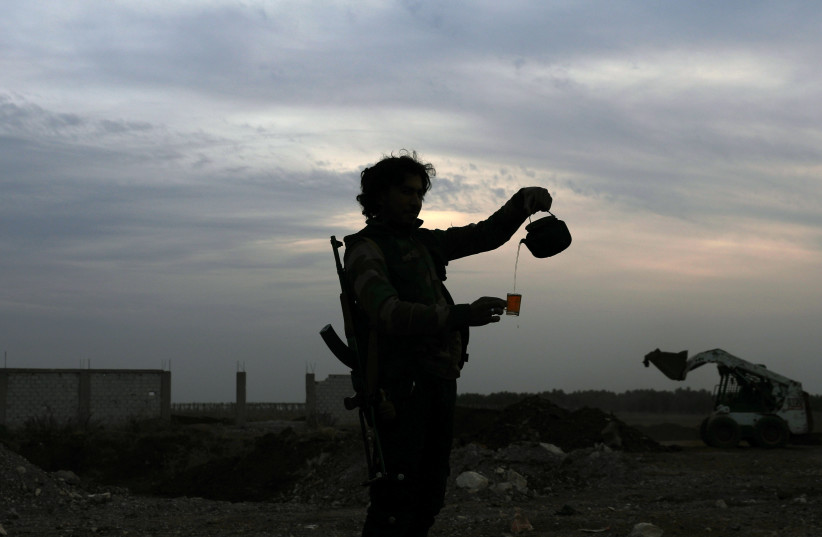 A Free Syrian army fighter pours tea in the rebel-held town of Dael, Syria. (photo credit: REUTERS)