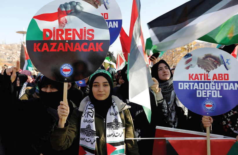 DEMONSTRATORS HOLD BANNERS and Turkish and Palestinian flags as they shout slogans during a protest against US President Donald Trump’s recognition of Jerusalem as Israel’s capital, after Friday prayers at Haci Bayram Mosque in Ankara, in December. (photo credit: REUTERS)