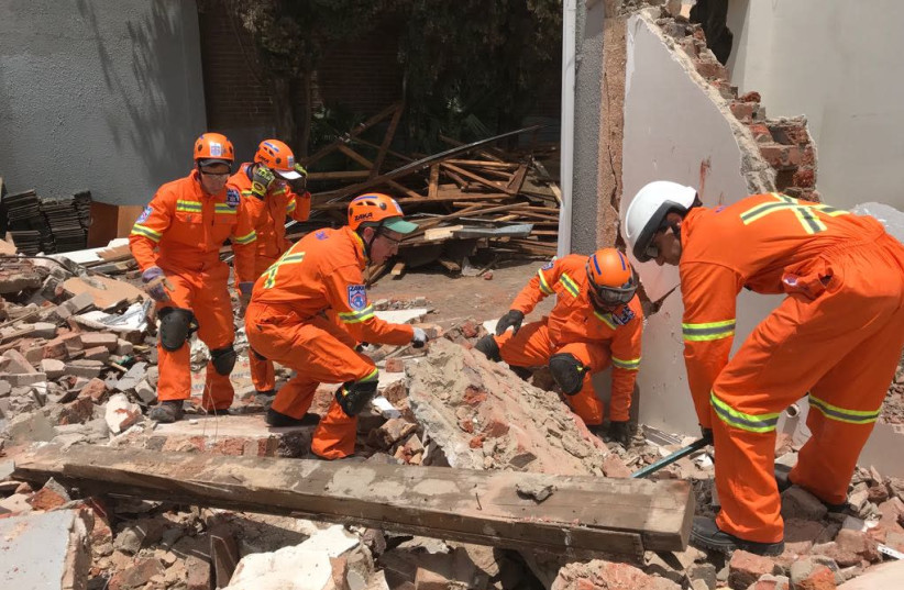 ZAKA volunteers in Johannesburg help with clean-up and relief efforts following severe storms that displaced thousands and left two people dead and over 50 people injured. (photo credit: Courtesy)