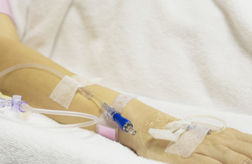 A patient in a hospital receives intravenous (IV) therapy (illustrative) (photo credit: INGIMAGE)