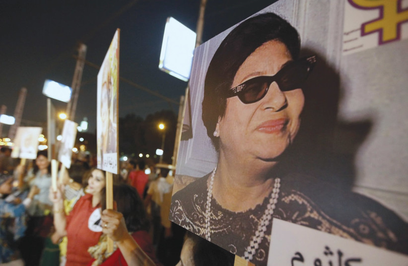 WOMEN CARRY photos of the late Egyptian singer Oum Kalthoum, who despite writing songs that included lyrics such as ‘Slaughter and have no pity... on the Zionist Jew,’ was beloved by Arabs and Israelis alike. (photo credit: AMR ABDALLAH DALSH / REUTERS)