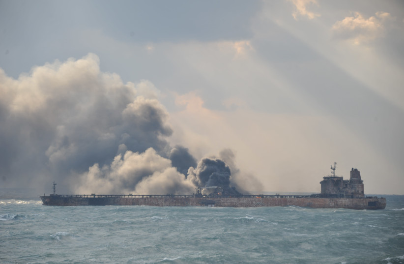 Smoke is seen from the Panama-registered Sanchi tanker carrying Iranian oil, which went ablaze after a collision with a Chinese freight ship in the East China Sea. (photo credit: REUTERS)