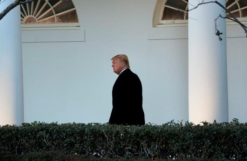US President Donald Trump walks to the Oval Office of the White House upon his return in Washington from Pittsburgh, US, January 18, 2018 (photo credit: REUTERS/YURI GRIPAS)