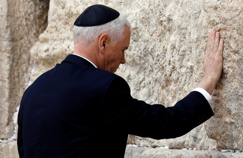 US Vice President Mike Pence touches the Western Wall, Judaism's holiest prayer site, in Jerusalem's Old City (photo credit: AMIR COHEN/REUTERS)