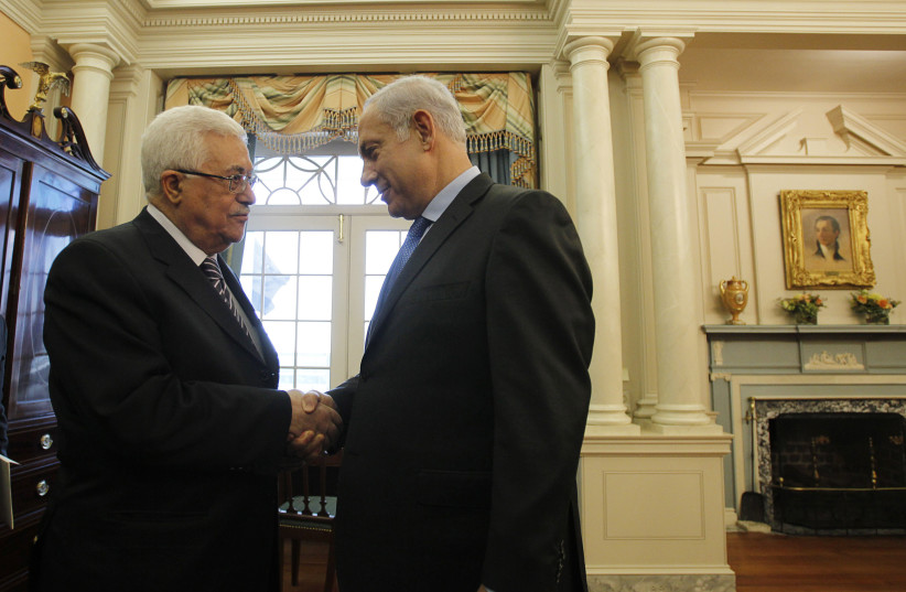 Israel's Prime Minister Benjamin Netanyahu (R) greets Palestinian President Mahmoud Abbas in the Monroe Room of the State Department in Washington September 2, 2010. (photo credit: REUTERS/JASON REED)