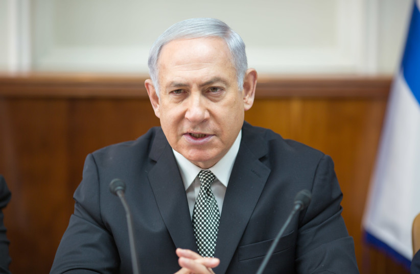 Prime Minister Benjamin Netanyahu at a weekly cabinet meeting on February 4, 2018. (photo credit: EMIL SALMAN/POOL)
