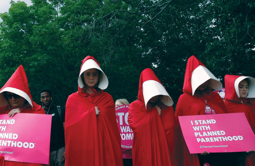 WOMEN DRESSED as handmaids from ‘The Handmaid’s Tale’ demonstrate in the US. (photo credit: REUTERS)