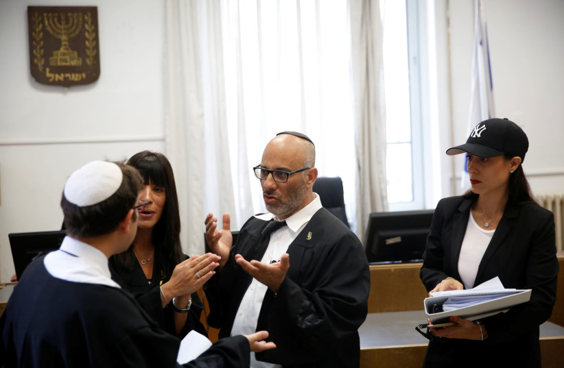 Yehuda Fried (C), lawyer of Malka Leifer, speaks to a state prosecutor (L) after a court session at the Jerusalem District Court (photo credit: RONEN ZVULUN / REUTERS)