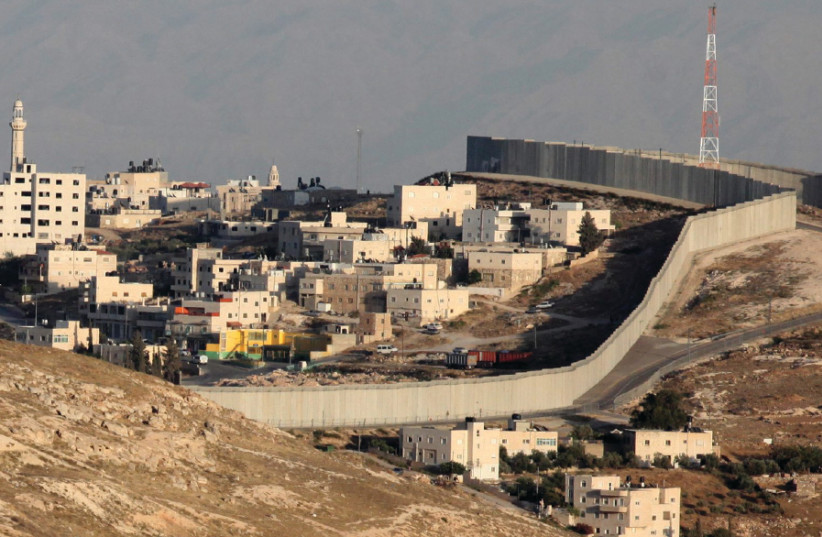 The east Jerusalem neighborhood of Abu Dis and the security barrier that separates it from the rest of the city (photo credit: MARC ISRAEL SELLEM)