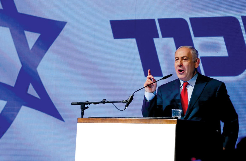 PRIME MINISTER Benjamin Netanyahu at a Likud party meeting last year. (Reuters) (photo credit: REUTERS)