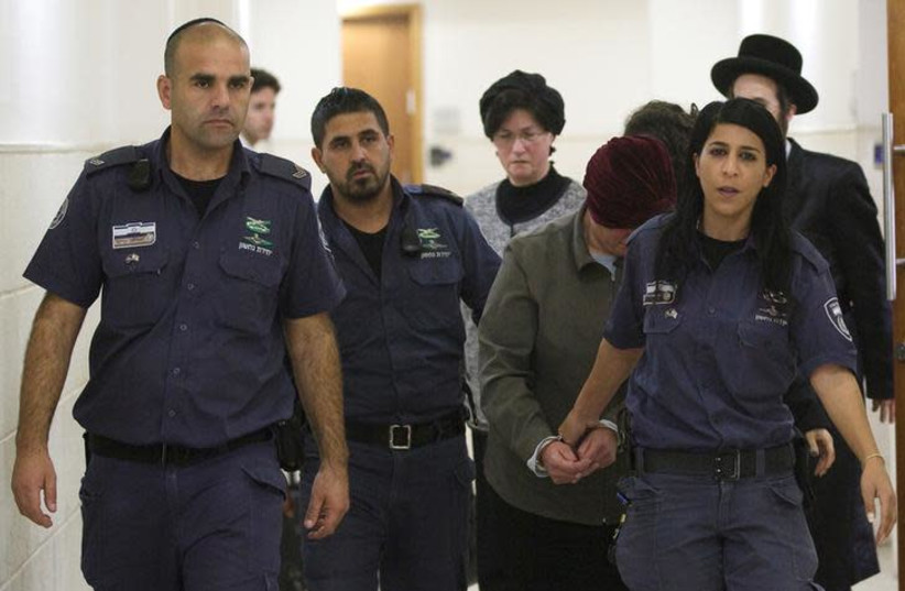 Malka Leifer, a former Australian school principal who is wanted in Australia on suspicion of sexually abusing students, walks in the corridor of the Jerusalem District Court accompanied by Israeli Prison Service guards, in Jerusalem February 14, 2018. REUTERS/Ronen Zvulun (photo credit: REUTERS/Ronen Zvulun)