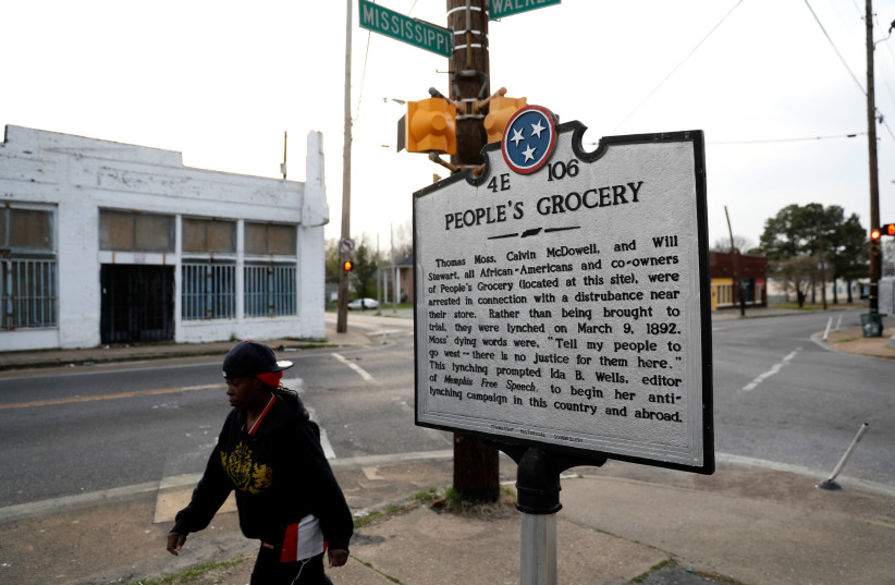 A marker on a street corner in the Soulsville neighbourhood marks the spot of the People's Grocery lynching of African-American proprietors Thomas Moss, Calvin McDowell and Will Stewart in 1892, which spurred Ida B. Wells in her crusade against lynching, in Memphis, Tennessee, U.S. March 26, 2018. (photo credit: JONATHAN ERNST / REUTERS)