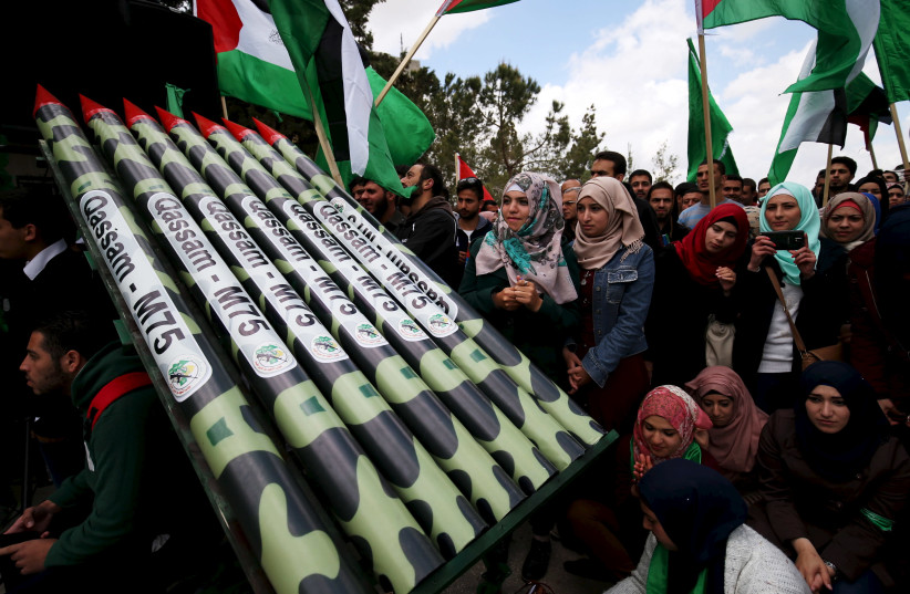 Palestinian students supporting Hamas stand next to mock Hamas rockets during a rally celebrating their winning of the student council election at Birzeit University in the West Bank city of Ramallah April 23, 2015. (photo credit: REUTERS/MOHAMAD TOROKMAN)