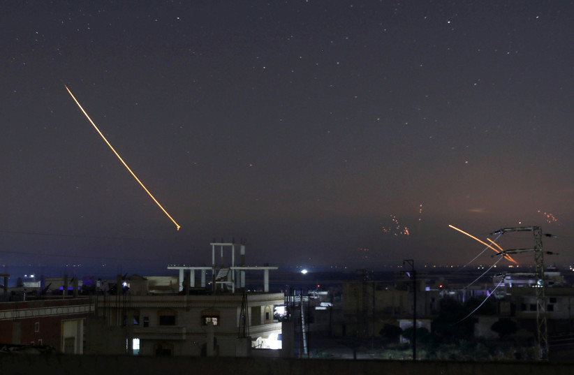 Missile fire is seen over Daraa, Syria, May 10, 2018 (photo credit: ALAA AL-FAKIR / REUTERS)
