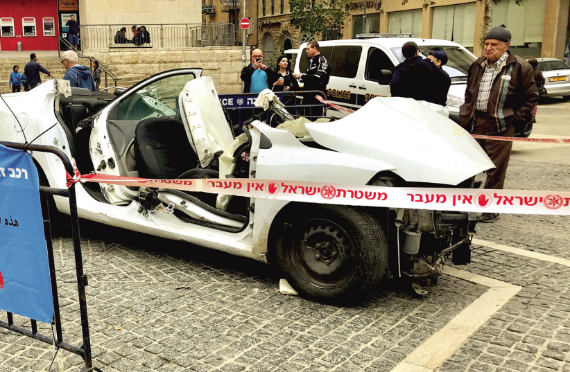 A CAR wreck exhibition surrounded by police tape in Jerusalem’s Zion Square last week (photo credit: ITTAY FLESCHER)