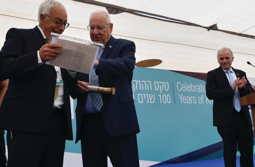 PRESIDENT REUVEN RIVLIN receives as a gift a letter written by his father in 1939 to the head of the university’s administration asking for a raise in salary because his wife wasn’t working and had just given birth to their first born son whose name was Reuven, at the Hebrew University in Jerusalem  (photo credit: KOBI GIDEON/GPO)