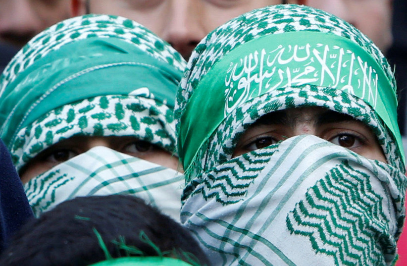 Palestinian Hamas supporters take part in a rally marking the 30th anniversary of Hamas' founding, in the West Bank city of Nablus December 15, (photo credit: ABED OMAR QUSINI/REUTERS)