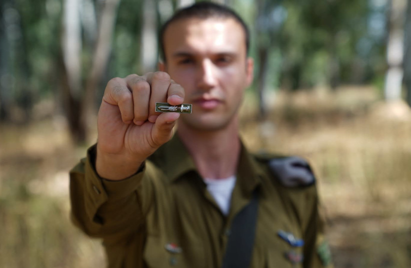 Soldier holding the newly designed pin (photo credit: COURTESY IDF SPOKESMAN'S OFFICE)