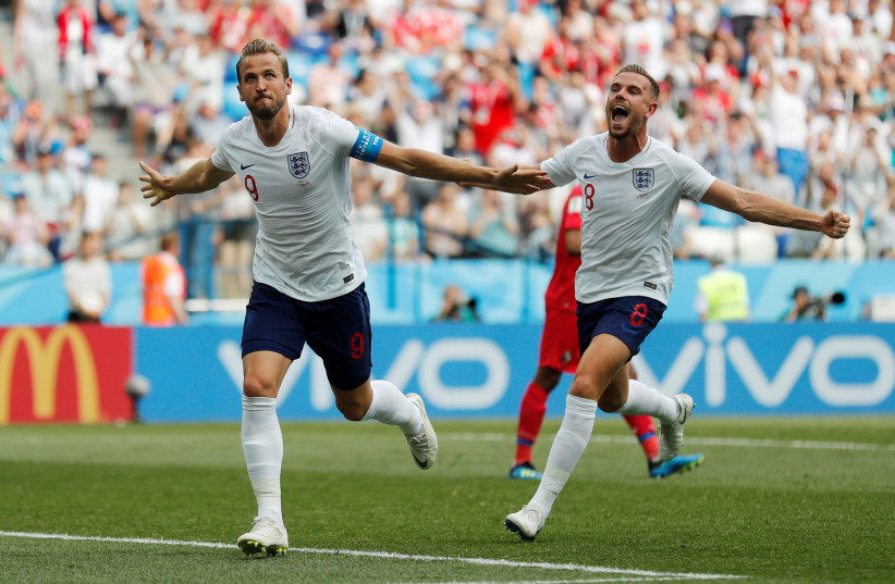 England's Harry Kane celebrates with Jordan Henderson after scoring their second goal against Panama, June 24, 2018 (photo credit: REUTERS/CARLOS BARRIA)
