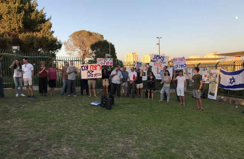 Demonstrators pushing for ethical arms sales protest outside the Knesset Tuesday, with signs reading 'Don't assist genocide,' 'No genocide with support of blue and white' and 'Jews don't arm evil' (photo credit: ELIANA SCHREIBER)
