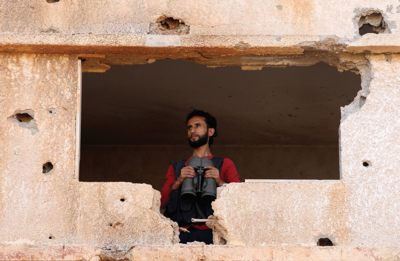 A FIGHTER from the Free Syrian Army is seen in the Yadouda area in Dera’a. (photo credit: REUTERS)